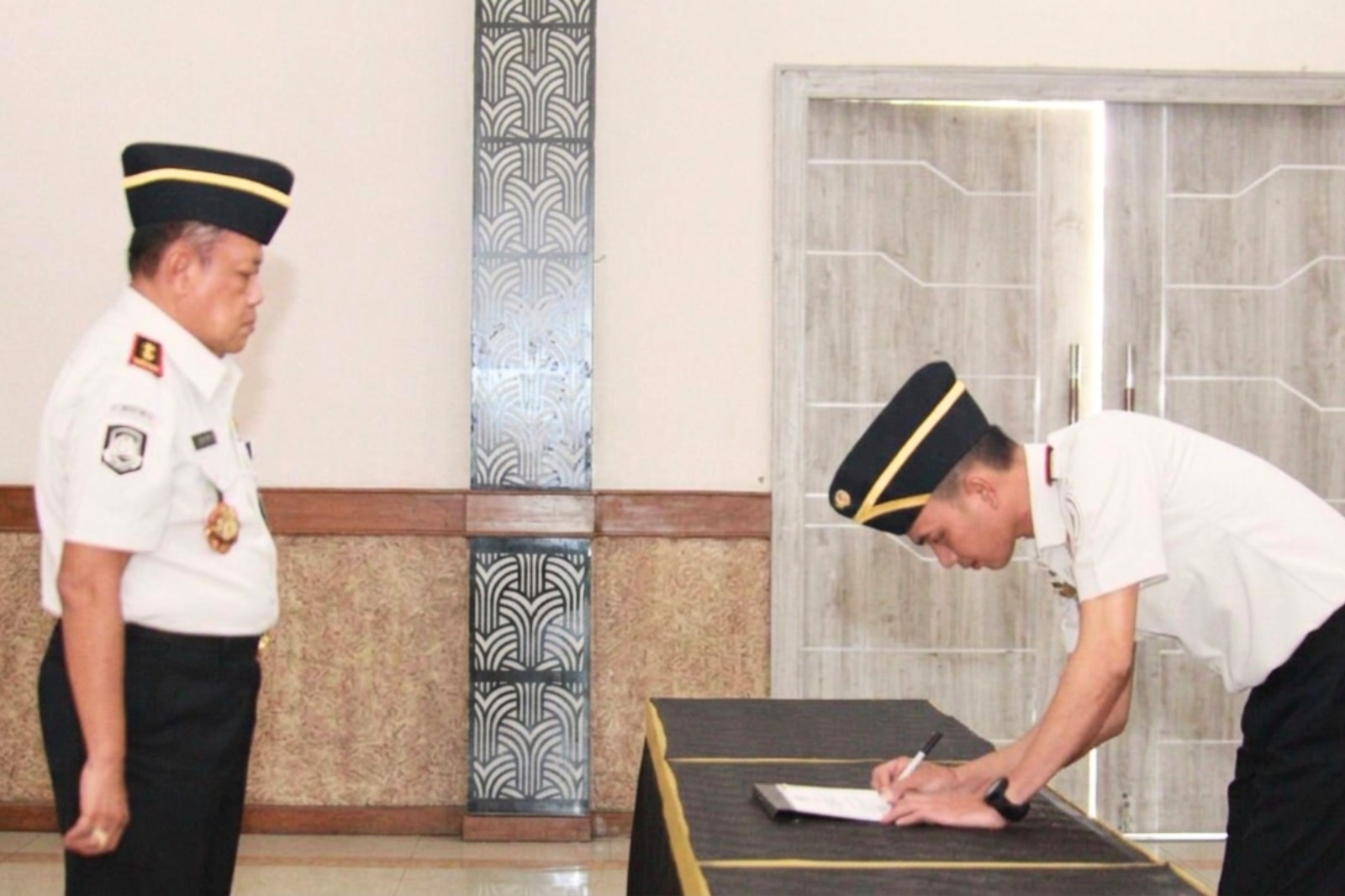 Kepala Kantor Imigrasi Kelas I TPI Cirebon Komang Trisna Diatmika menandatangani dokumen Pakta Integritas Tahun 2026 di hadapan Kepala Kantor Wilayah Direktorat Jenderal Imigrasi Jawa Barat Jaya Saputra pada kegiatan Penandatanganan Pakta Integritas di Aula Soepomo Kantor Wilayah Direktorat Jenderal Imigrasi Jawa Barat, Bandung, Senin (9/2/2026). Foto: Dok. Humas Kanwil Ditjenim Jabar.